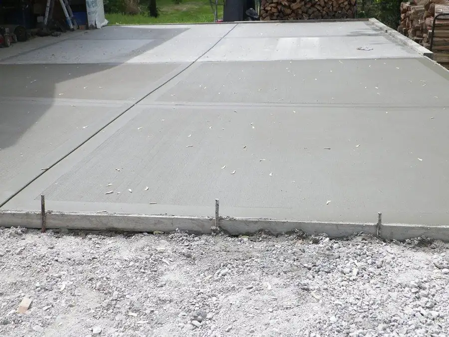 poured concrete slabs left to dry and forming a new driveway for residential home - Collinsville, IL