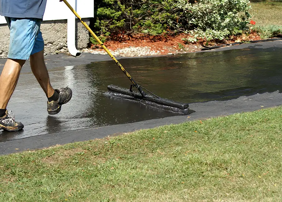 Asphalt driveway sealing, professional finishing off new asphalt driveway with sealant - Collinsville, IL