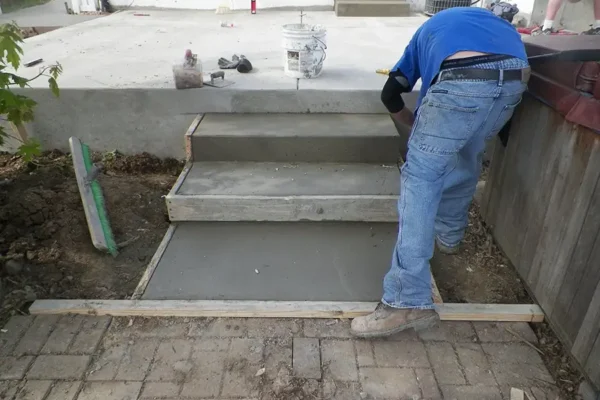 A+ Concrete - new concrete steps, professional removing wooden frame from fresh set concrete steps, stairs - Collinsville, IL